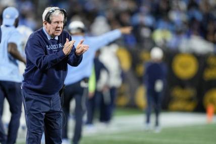 Dec 27, 2023; Charlotte, NC, USA; North Carolina Tar Heels head coach Mack Brown tries to cheer on his defense during the second half against the West Virginia Mountaineers at Bank of America Stadium. Mandatory Credit: Jim Dedmon-USA TODAY Sports