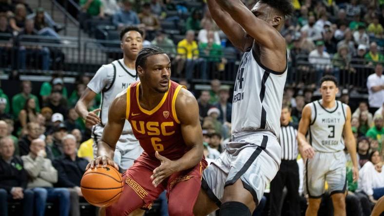 USC guard Bronny James drives under the basket under coverage from Oregon center Mahamadou Diawara as the Oregon Ducks host the USC Trojans Thursday, Dec. 28, 2023, at Matthew Knight Arena in Eugene, Ore.