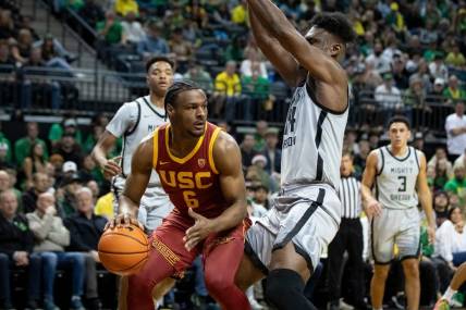 USC guard Bronny James drives under the basket under coverage from Oregon center Mahamadou Diawara as the Oregon Ducks host the USC Trojans Thursday, Dec. 28, 2023, at Matthew Knight Arena in Eugene, Ore.