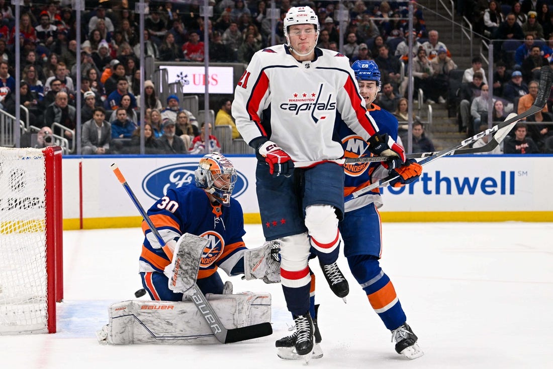 Dec 29, 2023; Elmont, New York, USA; New York Islanders goaltender Ilya Sorokin (30) makes a save as Washington Capitals center Aliaksei Protas (21) attempts s screen during the first period at UBS Arena. Mandatory Credit: Dennis Schneidler-USA TODAY Sports