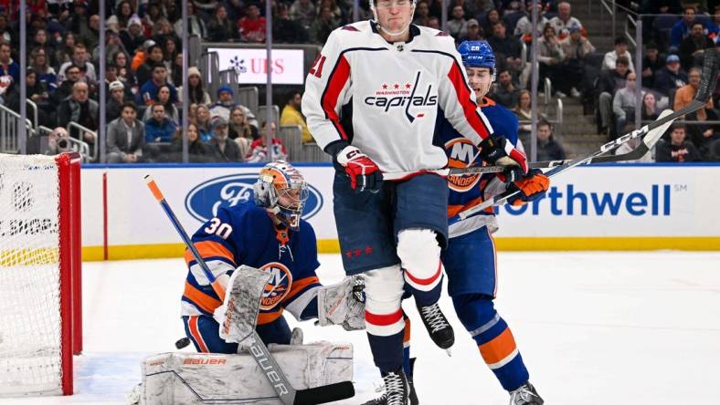 Dec 29, 2023; Elmont, New York, USA; New York Islanders goaltender Ilya Sorokin (30) makes a save as Washington Capitals center Aliaksei Protas (21) attempts s screen during the first period at UBS Arena. Mandatory Credit: Dennis Schneidler-USA TODAY Sports