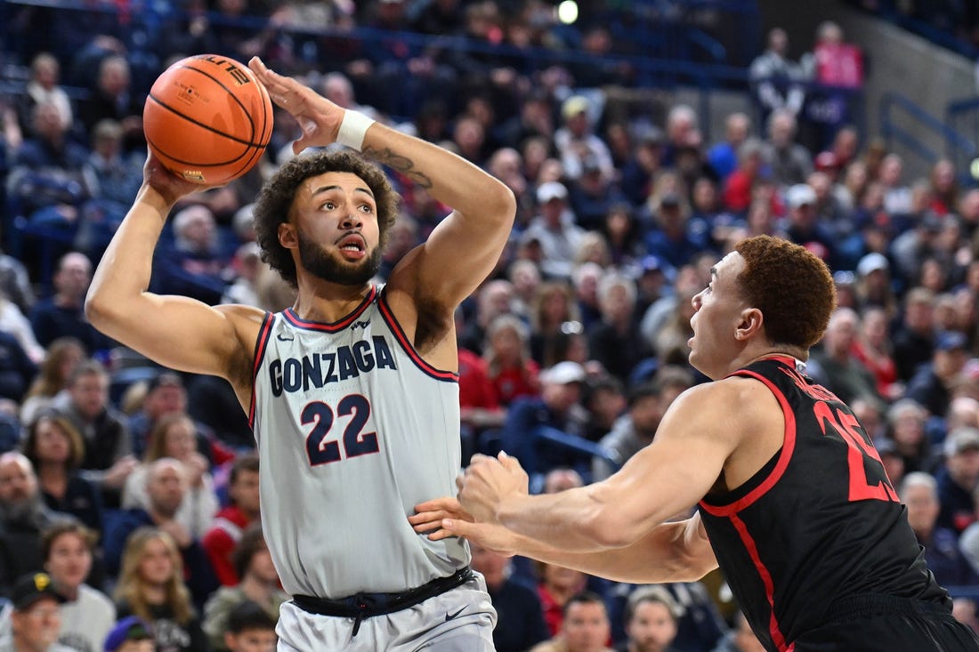 Dec 29, 2023; Spokane, Washington, USA; Gonzaga Bulldogs forward Anton Watson (22) shoots the ball against San Diego State Aztecs forward Elijah Saunders (25) in the first half at McCarthey Athletic Center. Mandatory Credit: James Snook-USA TODAY Sports