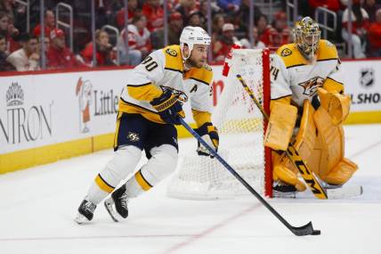 Dec 29, 2023; Detroit, Michigan, USA; Nashville Predators center Ryan O'Reilly (90) handles the puck during an overtime period of the game between the Detroit Red Wings and the Nashville Predators at Little Caesars Arena. Mandatory Credit: Brian Bradshaw Sevald-USA TODAY Sports