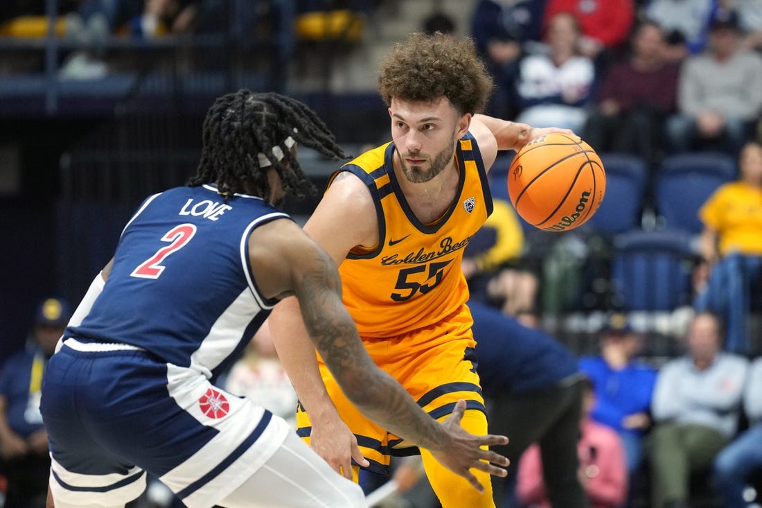 Dec 29, 2023; Berkeley, California, USA; California Golden Bears guard Devin Askew (55) handles the ball against Arizona Wildcats guard Caleb Love (2) during the first half at Haas Pavilion. Mandatory Credit: Darren Yamashita-USA TODAY Sports