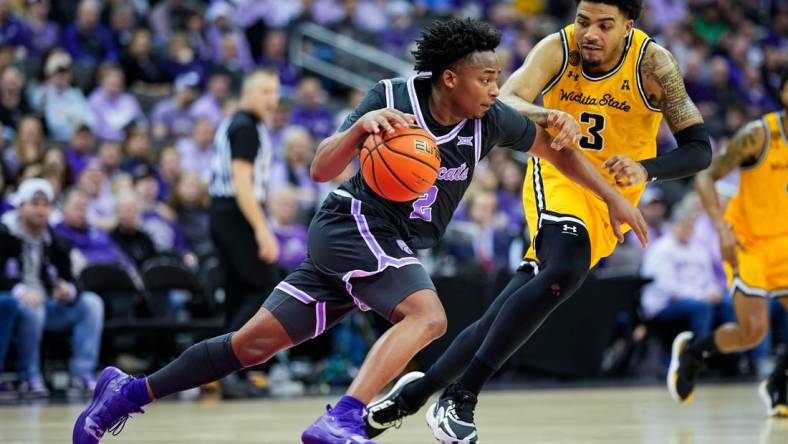 Dec 21, 2023; Kansas City, Missouri, USA; Kansas State Wildcats guard Tylor Perry (2) dribbles the ball against Wichita State Shockers forward Ronnie DeGray III (3) during the second half at T-Mobile Center. Mandatory Credit: Jay Biggerstaff-USA TODAY Sports