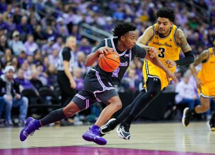 Dec 21, 2023; Kansas City, Missouri, USA; Kansas State Wildcats guard Tylor Perry (2) dribbles the ball against Wichita State Shockers forward Ronnie DeGray III (3) during the second half at T-Mobile Center. Mandatory Credit: Jay Biggerstaff-USA TODAY Sports