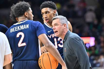 Dec 30, 2023; South Bend, Indiana, USA; Virginia Cavaliers head coach Tony Bennett talks to guard Reece Beekman (2) and guard Ryan Dunn (13) in the second half against the Notre Dame Fighting Irish at the Purcell Pavilion. Mandatory Credit: Matt Cashore-USA TODAY Sports