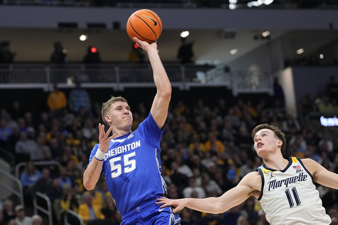 Dec 30, 2023; Milwaukee, Wisconsin, USA;  Creighton Bluejays guard Baylor Scheierman (55) shoots over Marquette Golden Eagles guard Tyler Kolek (11) during the first half at Fiserv Forum. Mandatory Credit: Jeff Hanisch-USA TODAY Sports