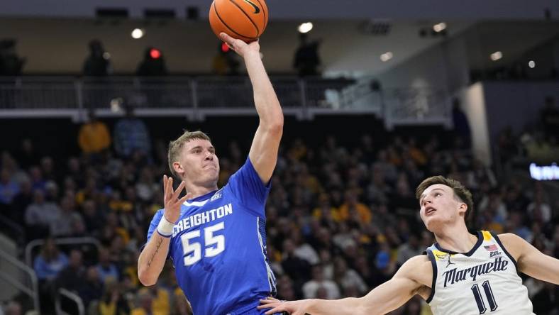 Dec 30, 2023; Milwaukee, Wisconsin, USA;  Creighton Bluejays guard Baylor Scheierman (55) shoots over Marquette Golden Eagles guard Tyler Kolek (11) during the first half at Fiserv Forum. Mandatory Credit: Jeff Hanisch-USA TODAY Sports