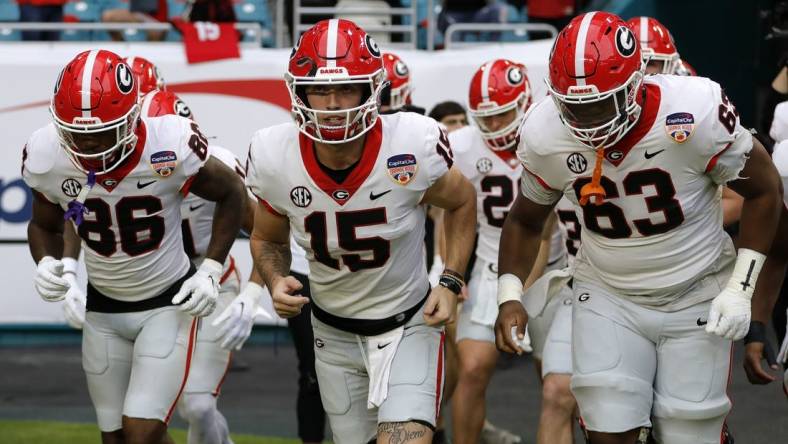 Dec 30, 2023; Miami Gardens, FL, USA; Georgia Bulldogs quarterback Carson Beck (15) leads the team onto the field before the game against the Florida State Seminoles for the 2023 Orange Bowl at Hard Rock Stadium. Mandatory Credit: Sam Navarro-USA TODAY Sports