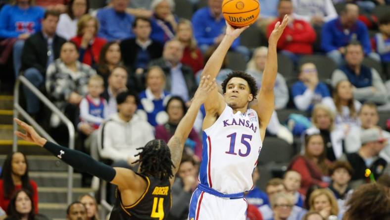 Kansas graduate senior guard Kevin McCullar Jr. (15) shoots for three against Wichita State during the second half of Saturday's game inside T-Mobile Center in Kansas City.