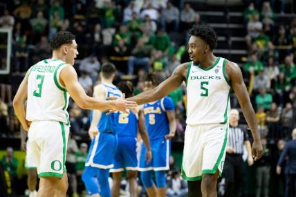 Oregon guard Jermaine Couisnard and Oregon guard Jackson Shelstad celebrate in the second half as the Oregon Ducks host the UCLA Bruins Saturday, Dec. 30, 2023, at Matthew Knight Arena in Eugene, Ore.