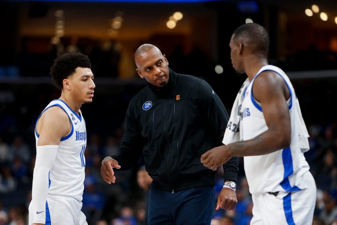 Memphis' Jahvon Quinerly (11) and David Jones (8) speak with head coach Penny Hardaway during the game between Austin Peay State University and University of Memphis at FedExForum in Memphis, Tenn., on Saturday, December 30, 2023.