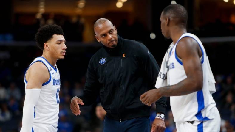 Memphis' Jahvon Quinerly (11) and David Jones (8) speak with head coach Penny Hardaway during the game between Austin Peay State University and University of Memphis at FedExForum in Memphis, Tenn., on Saturday, December 30, 2023.