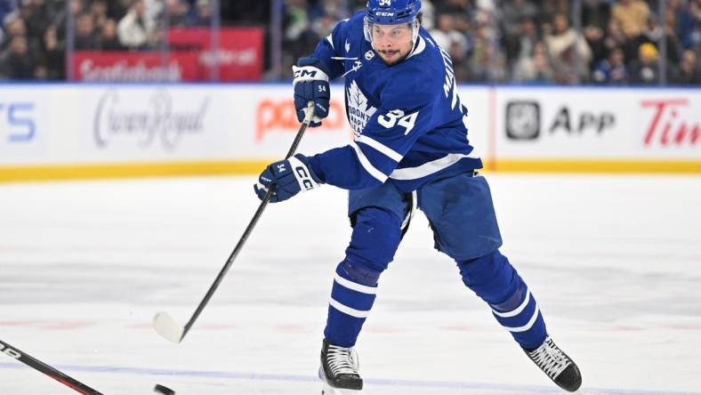 Dec 30, 2023; Toronto, Ontario, CAN; Toronto Maple Leafs forward Auston Matthews (34) shoots the puck against the Carolina Hurricanes in the first period at Scotiabank Arena. Mandatory Credit: Dan Hamilton-USA TODAY Sports