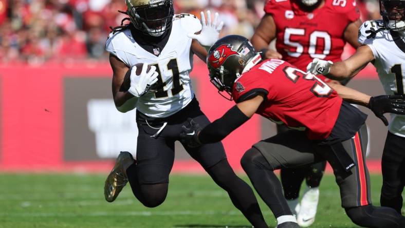 Dec 31, 2023; Tampa, Florida, USA;New Orleans Saints running back Alvin Kamara (41)  stiff arms Tampa Bay Buccaneers safety Antoine Winfield Jr. (31) during the first quarter at Raymond James Stadium. Mandatory Credit: Kim Klement Neitzel-USA TODAY Sports