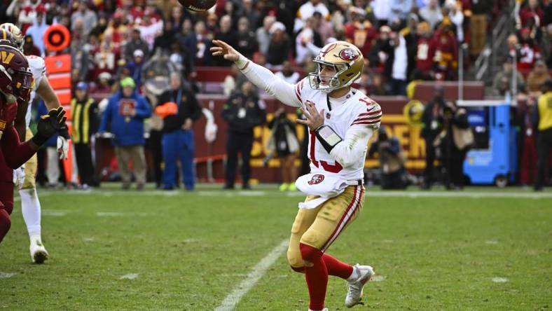 Dec 31, 2023; Landover, Maryland, USA; San Francisco 49ers quarterback Brock Purdy (13) attempts a pass against the Washington Commanders during the second half at FedExField. Mandatory Credit: Brad Mills-USA TODAY Sports