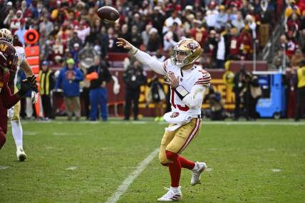 Dec 31, 2023; Landover, Maryland, USA; San Francisco 49ers quarterback Brock Purdy (13) attempts a pass against the Washington Commanders during the second half at FedExField. Mandatory Credit: Brad Mills-USA TODAY Sports
