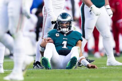 Dec 31, 2023; Philadelphia, Pennsylvania, USA; Philadelphia Eagles quarterback Jalen Hurts (1) sits on the field after being tackled during the fourth quarter against the Arizona Cardinals at Lincoln Financial Field. Mandatory Credit: Bill Streicher-USA TODAY Sports