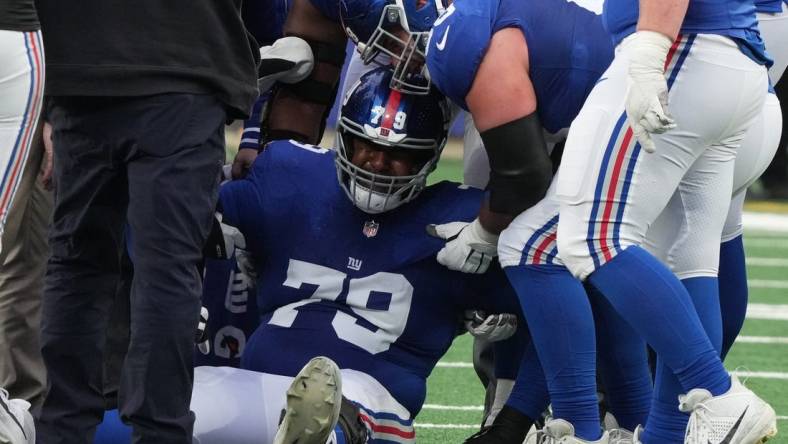 East Rutherford, NJ, Dec. 31, 2023 -- Right tackle Tyre Phillips of the Giants had to be carted off the field in the second half.