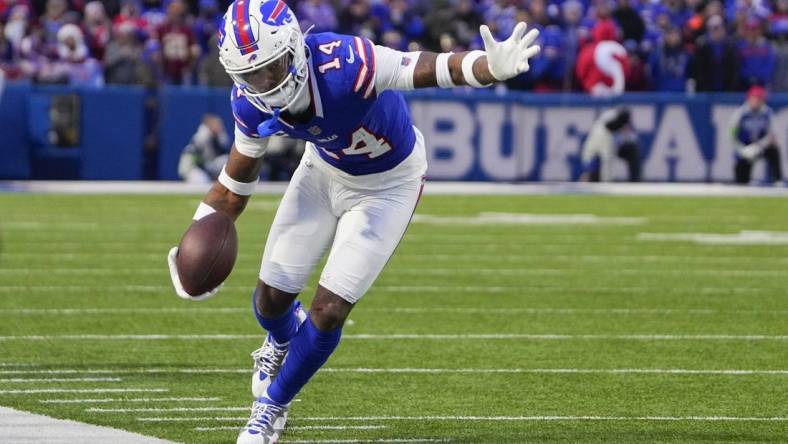 Dec 31, 2023; Orchard Park, New York, USA; Buffalo Bills wide receiver Stefon Diggs (14) runs with the ball along the sidelines after making a catch against the New England Patriots during the second half at Highmark Stadium. Mandatory Credit: Gregory Fisher-USA TODAY Sports