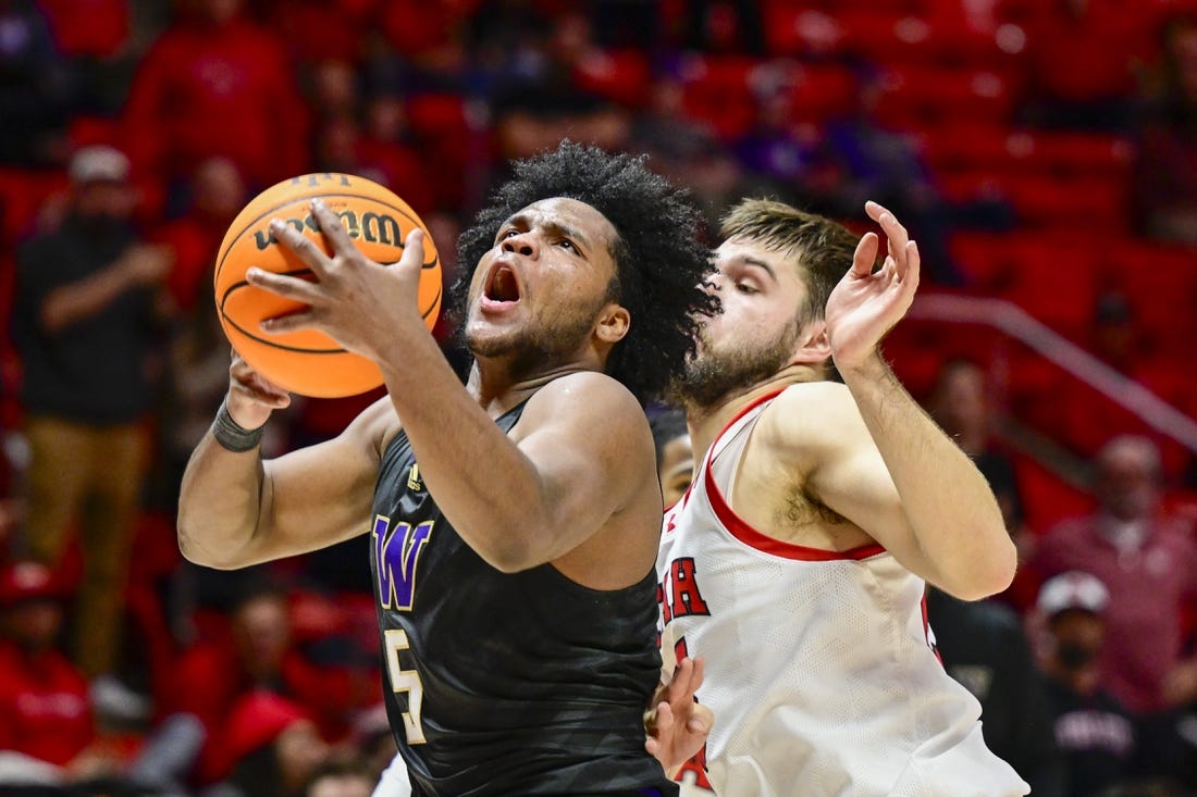 Dec 31, 2023; Salt Lake City, Utah, USA; Washington Huskies guard Sahvir Wheeler (5) takes a shot over Utah Utes guard Rollie Worster (25) during the second half at the the Jon M. Huntsman Center. Mandatory Credit: Christopher Creveling-USA TODAY Sports