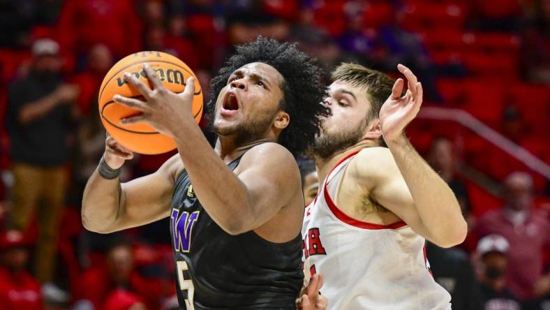 Dec 31, 2023; Salt Lake City, Utah, USA; Washington Huskies guard Sahvir Wheeler (5) takes a shot over Utah Utes guard Rollie Worster (25) during the second half at the the Jon M. Huntsman Center. Mandatory Credit: Christopher Creveling-USA TODAY Sports