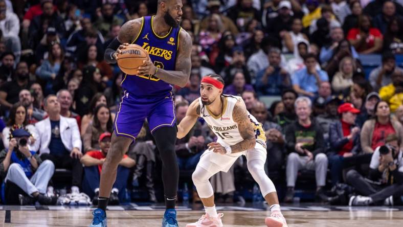 Dec 31, 2023; New Orleans, Louisiana, USA;  New Orleans Pelicans guard Jose Alvarado (15) guards Los Angeles Lakers forward LeBron James (23) during the second half at Smoothie King Center. Mandatory Credit: Stephen Lew-USA TODAY Sports