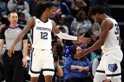 Dec 31, 2023; Memphis, Tennessee, USA; Memphis Grizzlies guard Ja Morant (12) reacts with guard Marcus Smart (36) during the second half against the Sacramento Kings at FedExForum. Mandatory Credit: Petre Thomas-USA TODAY Sports