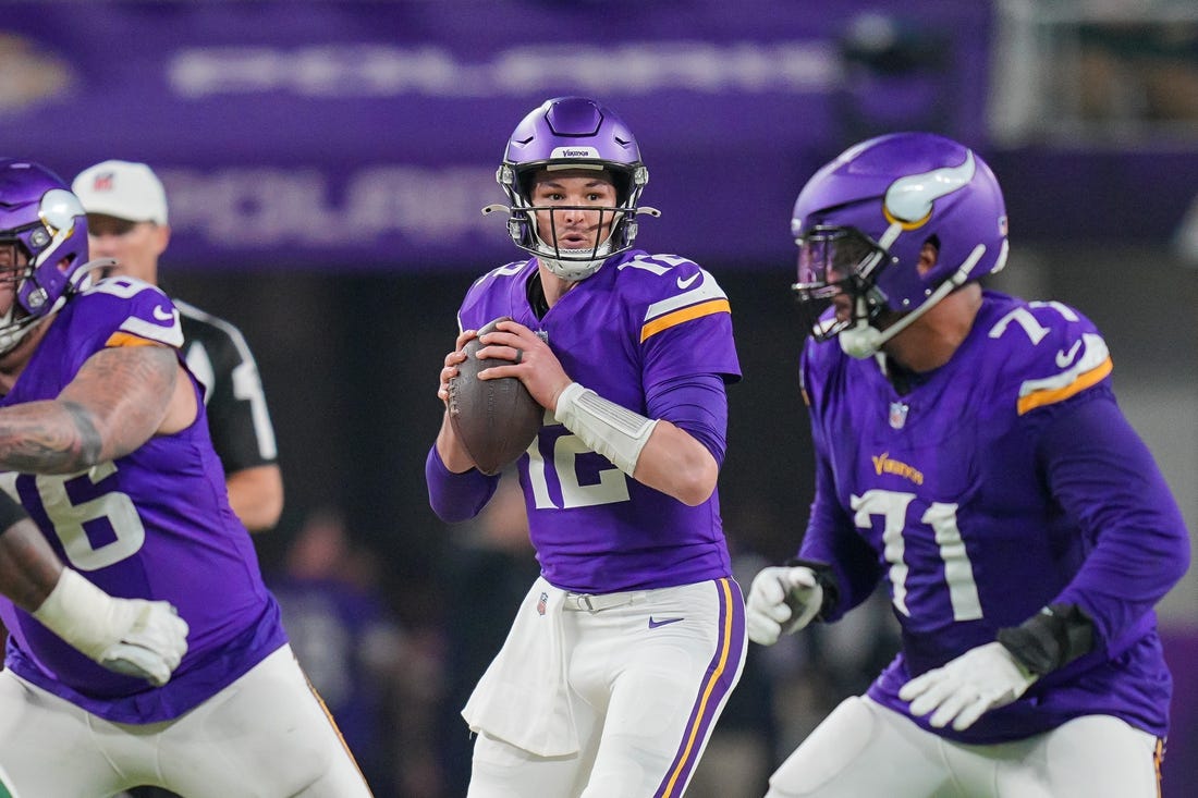 Dec 31, 2023; Minneapolis, Minnesota, USA; Minnesota Vikings quarterback Nick Mullens (12) drops back to pass against the Green Bay Packers in the third quarter at U.S. Bank Stadium. Mandatory Credit: Brad Rempel-USA TODAY Sports