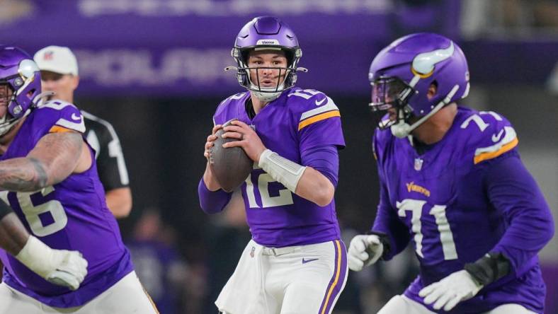 Dec 31, 2023; Minneapolis, Minnesota, USA; Minnesota Vikings quarterback Nick Mullens (12) drops back to pass against the Green Bay Packers in the third quarter at U.S. Bank Stadium. Mandatory Credit: Brad Rempel-USA TODAY Sports