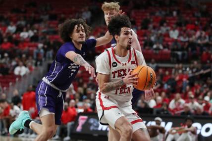 Jan 1, 2024; Lubbock, Texas, USA; Texas Tech Red Raiders guard Pop Isaacs (2) stops to take a shot against  North Alabama Lions guard KJ Johnson (3) in the first half  at United Supermarkets Arena. Mandatory Credit: Michael C. Johnson-USA TODAY Sports