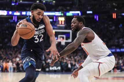 Jan 1, 2024; New York, New York, USA;  Minnesota Timberwolves center Karl-Anthony Towns (32) looks to drive past New York Knicks forward Julius Randle (30) in the first quarter at Madison Square Garden. Mandatory Credit: Wendell Cruz-USA TODAY Sports