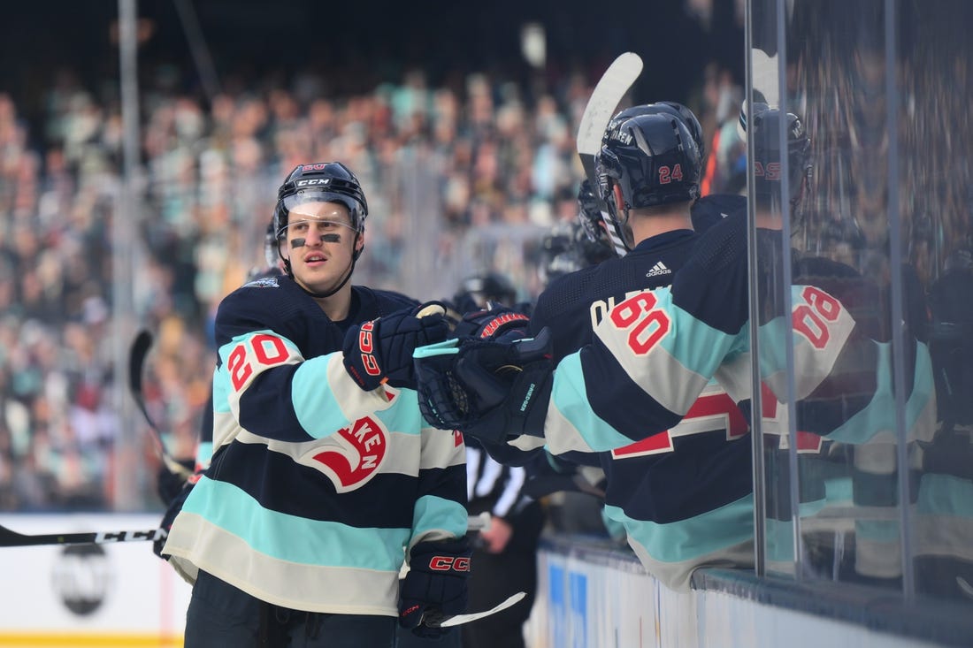 Jan 1, 2024; Seattle, Washington, USA; Seattle Kraken right wing Eeli Tolvanen (20) celebrates with the bench after scoring a goal against the Vegas Golden Knights during the first period in the 2024 Winter Classic ice hockey game at T-Mobile Park. Mandatory Credit: Steven Bisig-USA TODAY Sports