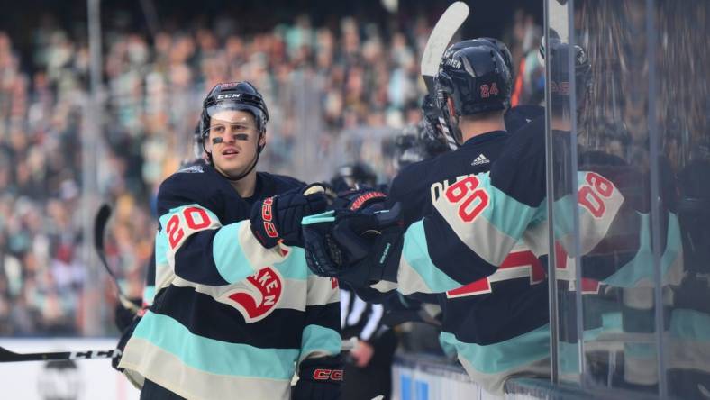 Jan 1, 2024; Seattle, Washington, USA; Seattle Kraken right wing Eeli Tolvanen (20) celebrates with the bench after scoring a goal against the Vegas Golden Knights during the first period in the 2024 Winter Classic ice hockey game at T-Mobile Park. Mandatory Credit: Steven Bisig-USA TODAY Sports