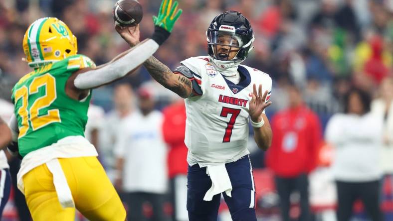 Jan 1, 2024; Glendale, AZ, USA; Liberty Flames quarterback Kaidon Salter (7) throws the ball under pressure from Oregon Ducks linebacker Emar'rion Winston (32) during the second half in the 2024 Fiesta Bowl at State Farm Stadium. Mandatory Credit: Mark J. Rebilas-USA TODAY Sports