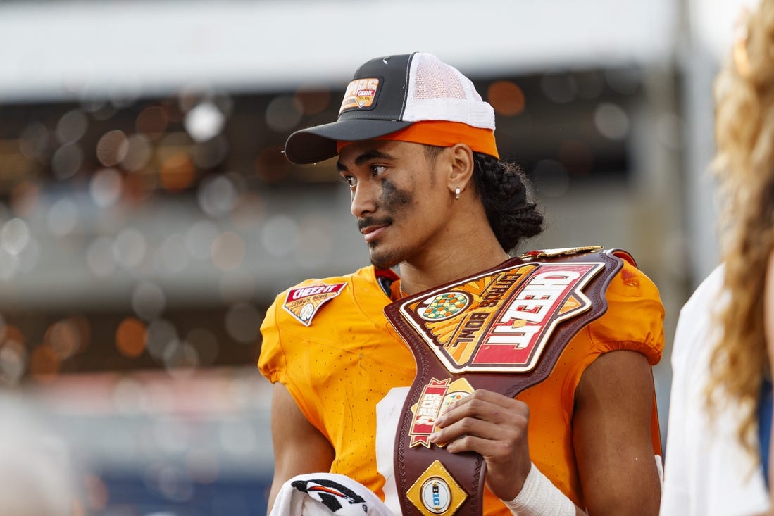 Jan 1, 2024; Orlando, FL, USA; Tennessee Volunteers quarterback Nico Iamaleava (8) poses with the MVP Trophy after defeating the Iowa Hawkeyes at Camping World Stadium. Mandatory Credit: Morgan Tencza-USA TODAY Sports