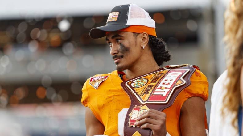 Jan 1, 2024; Orlando, FL, USA; Tennessee Volunteers quarterback Nico Iamaleava (8) poses with the MVP Trophy after defeating the Iowa Hawkeyes at Camping World Stadium. Mandatory Credit: Morgan Tencza-USA TODAY Sports