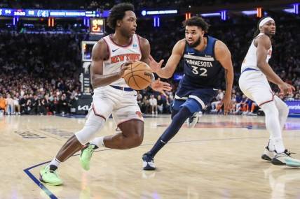 Jan 1, 2024; New York, New York, USA;  New York Knicks forward OG Anunoby (8) looks to drive past Minnesota Timberwolves center Karl-Anthony Towns (32) in the fourth quarter at Madison Square Garden. Mandatory Credit: Wendell Cruz-USA TODAY Sports