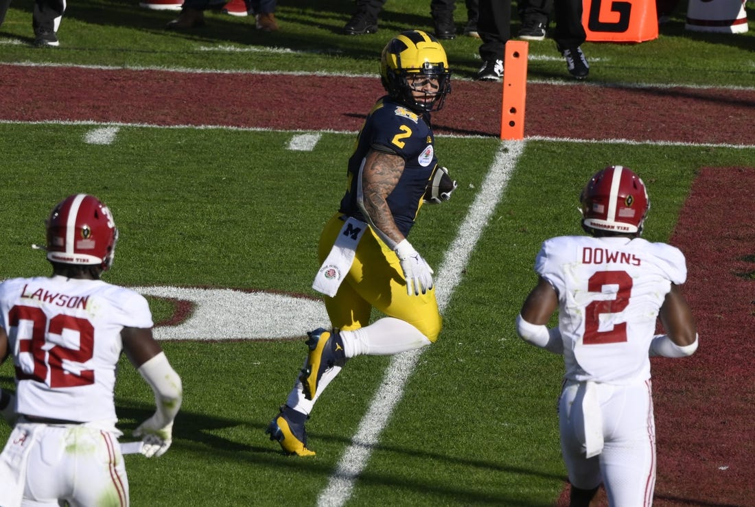 Jan 1, 2024; Pasadena, CA, USA; Michigan Wolverines running back Blake Corum (2) scores a touchdown past Alabama Crimson Tide linebacker Deontae Lawson (32) and defensive back Caleb Downs (2) in the 2nd quarter of the 2024 Rose Bowl college football playoff semifinal game at Rose Bowl. Mandatory Credit: Robert Hanashiro-USA TODAY Sports