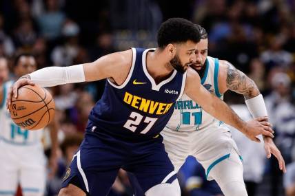 Jan 1, 2024; Denver, Colorado, USA; Denver Nuggets guard Jamal Murray (27) controls the ball against Charlotte Hornets forward Cody Martin (11) in the second quarter at Ball Arena. Mandatory Credit: Isaiah J. Downing-USA TODAY Sports