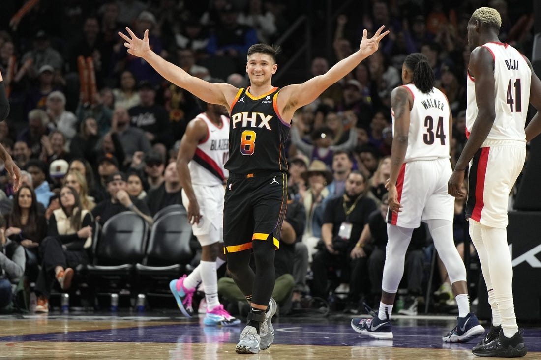 Jan 1, 2024; Phoenix, Arizona, USA; Phoenix Suns guard Grayson Allen (8) reacts after guard Devin Booker (1) makes a basket against the Portland Trail Blazers in the second half at Footprint Center. Mandatory Credit: Rick Scuteri-USA TODAY Sports