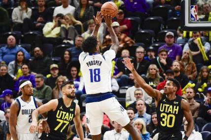 Jan 1, 2024; Salt Lake City, Utah, USA; Dallas Mavericks forward Olivier-Maxence Prosper (18) shoots over Utah Jazz guard Ochai Agbaji (30) during the second half at the Delta Center. Mandatory Credit: Christopher Creveling-USA TODAY Sports