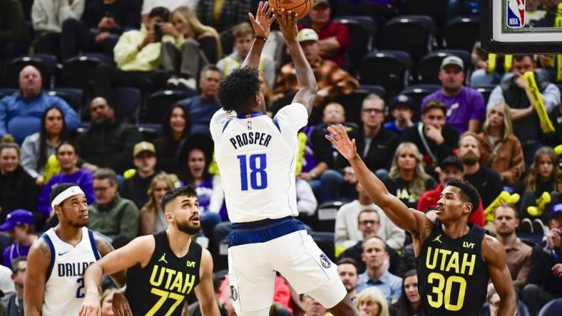 Jan 1, 2024; Salt Lake City, Utah, USA; Dallas Mavericks forward Olivier-Maxence Prosper (18) shoots over Utah Jazz guard Ochai Agbaji (30) during the second half at the Delta Center. Mandatory Credit: Christopher Creveling-USA TODAY Sports