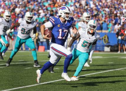 Bills quarterback Josh Allen tucks the ball and scores a touchdown against the Dolphins.