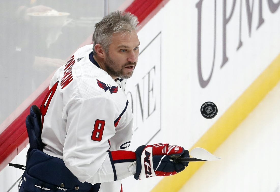 Jan 2, 2024; Pittsburgh, Pennsylvania, USA;  Washington Capitals left wing Alex Ovechkin (8) juggles the puck to warm up before the game against the Pittsburgh Penguins at PPG Paints Arena. Mandatory Credit: Charles LeClaire-USA TODAY Sports