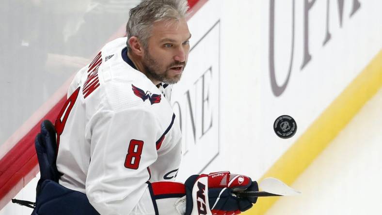 Jan 2, 2024; Pittsburgh, Pennsylvania, USA;  Washington Capitals left wing Alex Ovechkin (8) juggles the puck to warm up before the game against the Pittsburgh Penguins at PPG Paints Arena. Mandatory Credit: Charles LeClaire-USA TODAY Sports