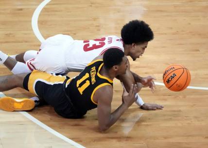 Jan 2, 2024; Madison, Wisconsin, USA;  Wisconsin Badgers guard Chucky Hepburn (23) and Iowa Hawkeyes guard Tony Perkins (11) go after a loose ball during the first half at the Kohl Center. Mandatory Credit: Kayla Wolf-USA TODAY Sports
