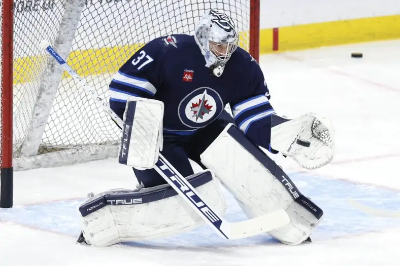 Jan 2, 2024; Winnipeg, Manitoba, CAN;  Winnipeg Jets goaltender Connor Hellebuyck (37) warms up before a game against the Tampa Bay Lightning at Canada Life Centre. Mandatory Credit: James Carey Lauder-USA TODAY Sports