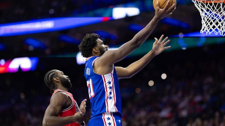 Jan 2, 2024; Philadelphia, Pennsylvania, USA; Philadelphia 76ers center Joel Embiid (21) drives for a score past Chicago Bulls forward Patrick Williams (44) during the second quarter at Wells Fargo Center. Mandatory Credit: Bill Streicher-USA TODAY Sports